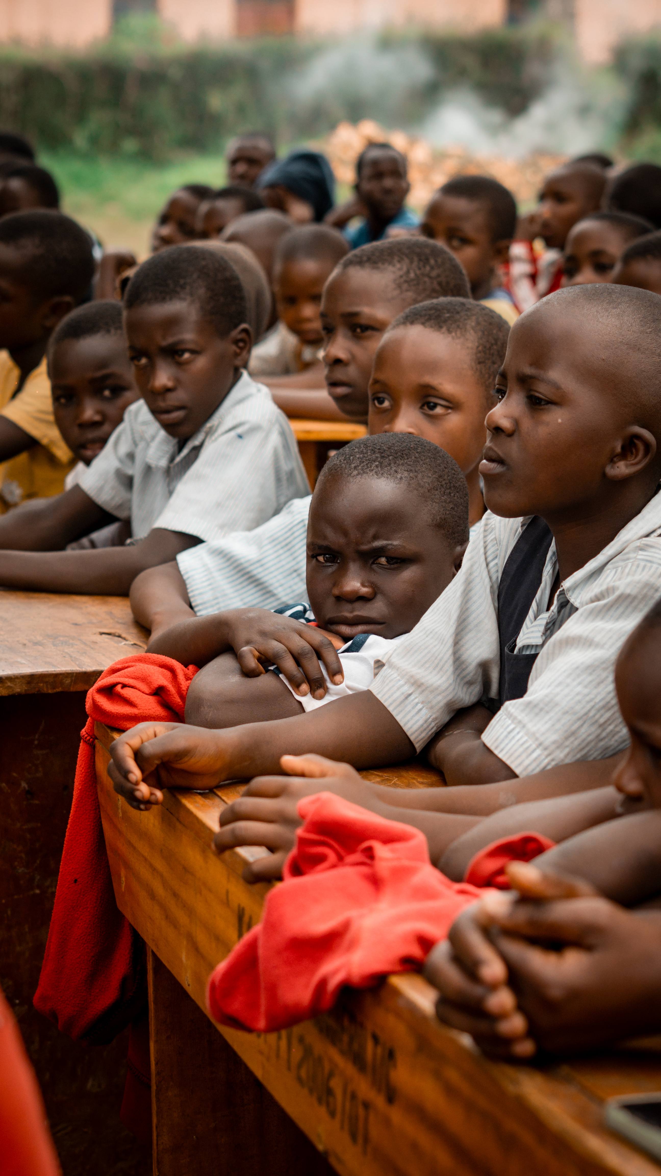 Close-up of students at wooden desks