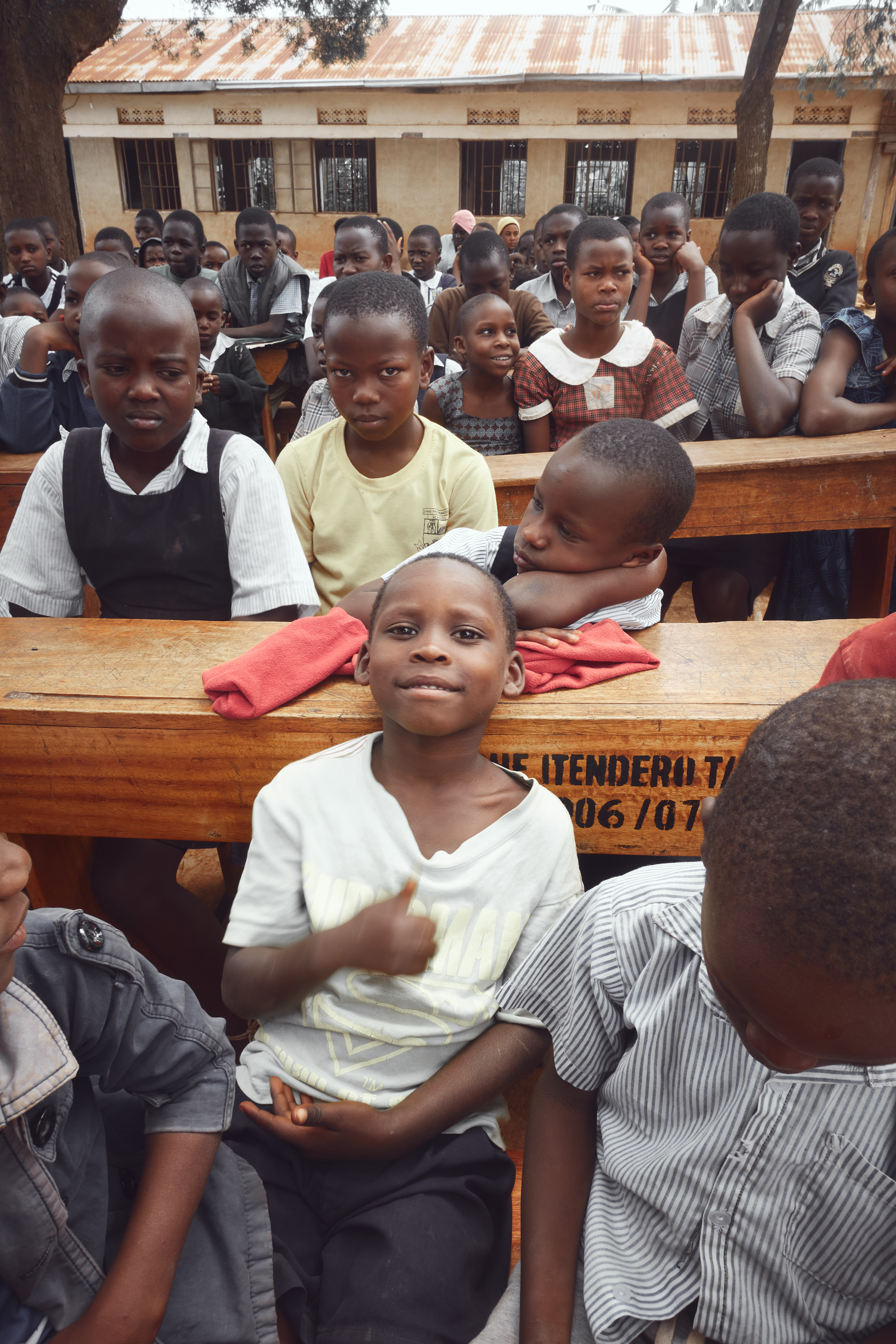 Students looking at camera in front of school building